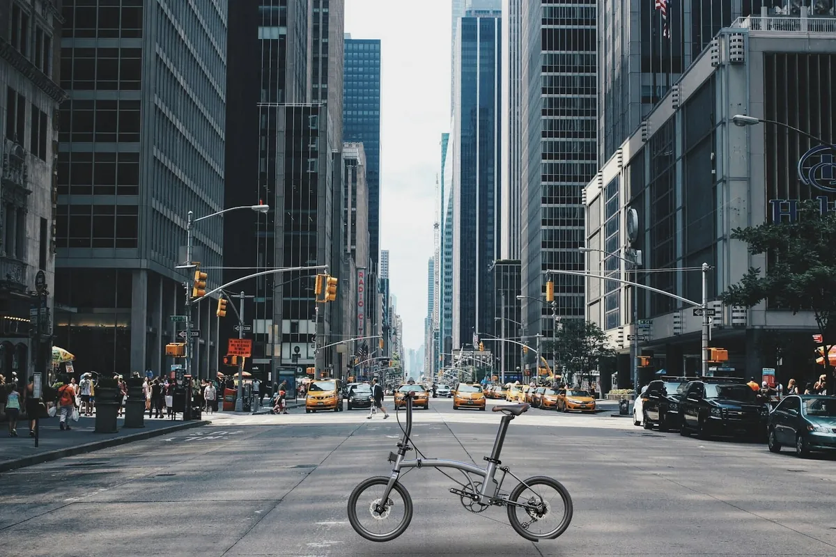 Folding ebike with mid-drive motor carried into metro – Bamboo Flute by Geektion