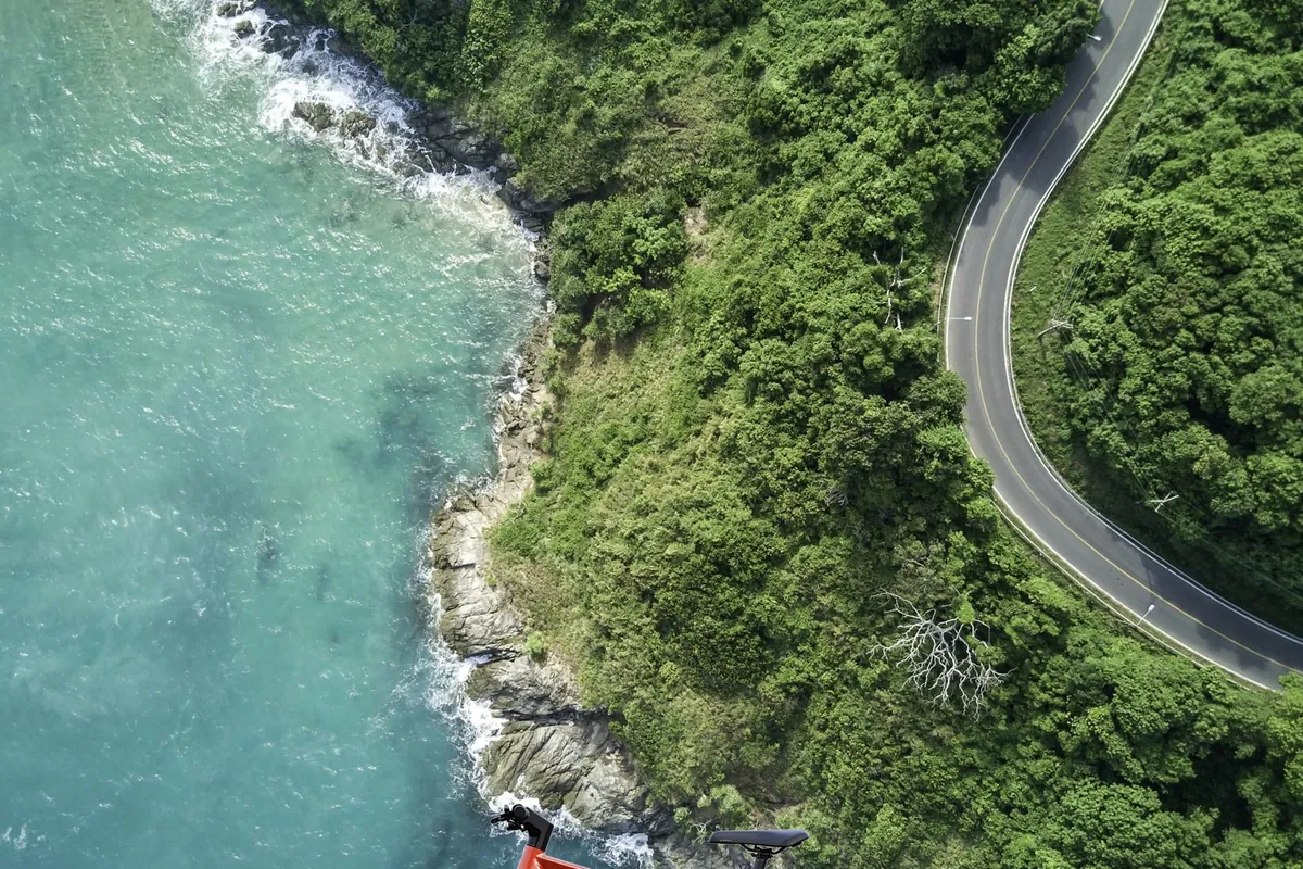 700c touring ebike with panniers on coastal road – Zenith Tourer long distance